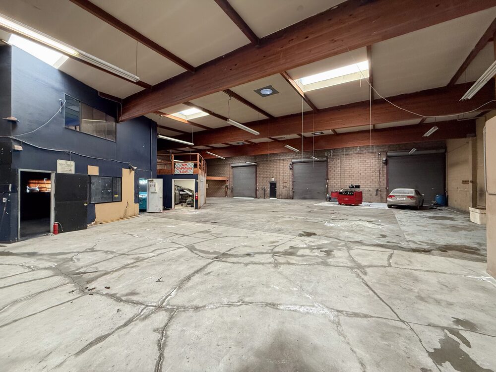 301 Barneveld Avenue warehouse interior with timber beams and roll-up doors