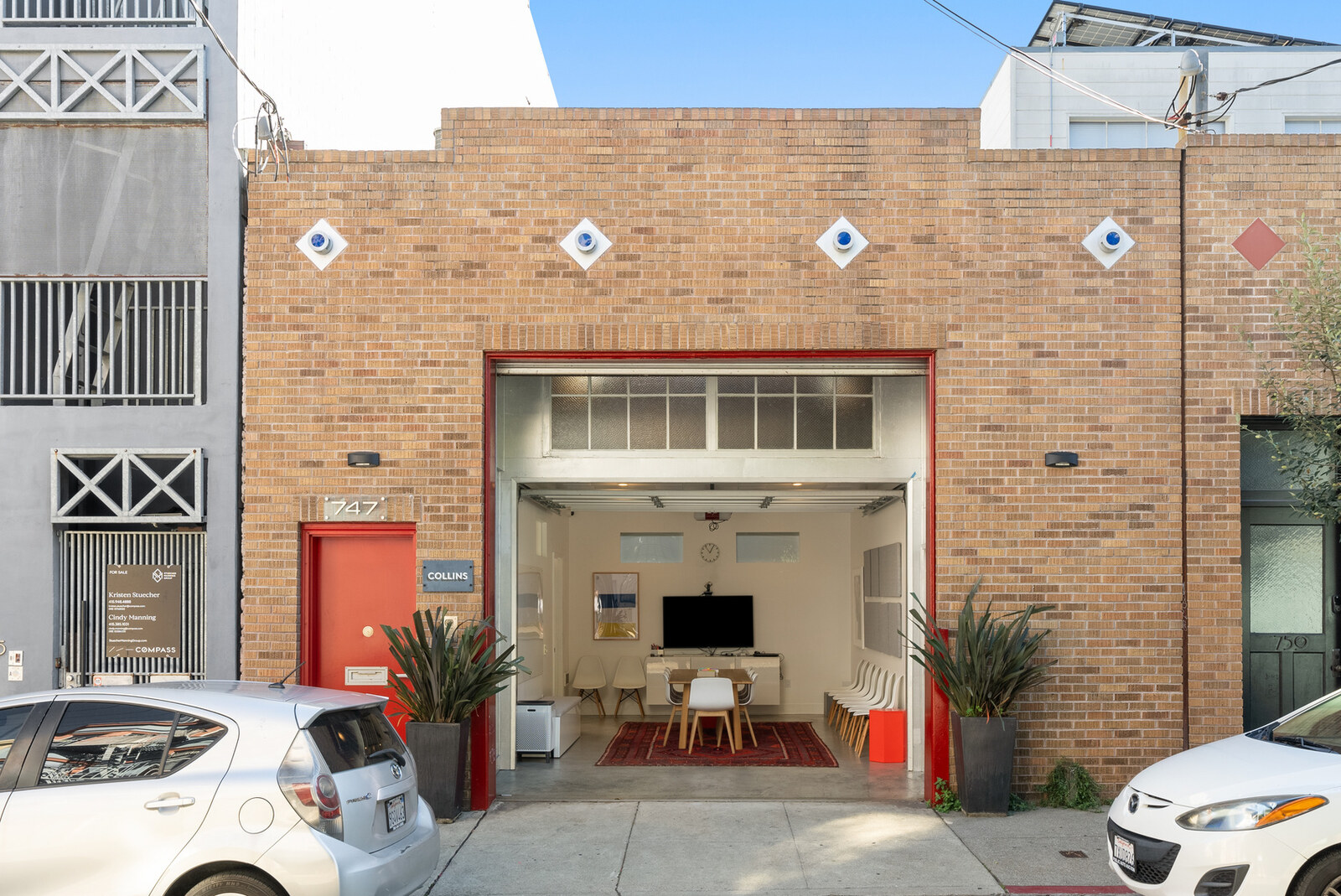 747 Clementina Street brick facade with red roll-up door