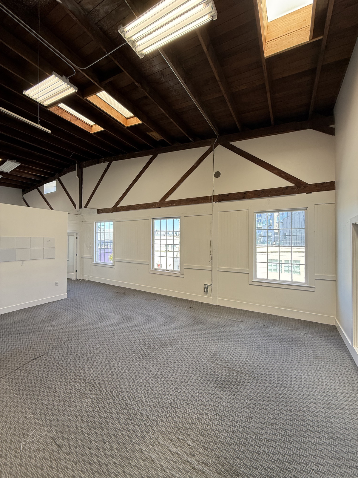 1045 17th Street open space with skylights and exposed timber ceiling